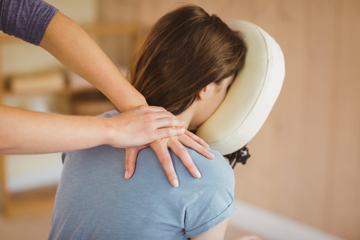 Young woman getting massage in chair